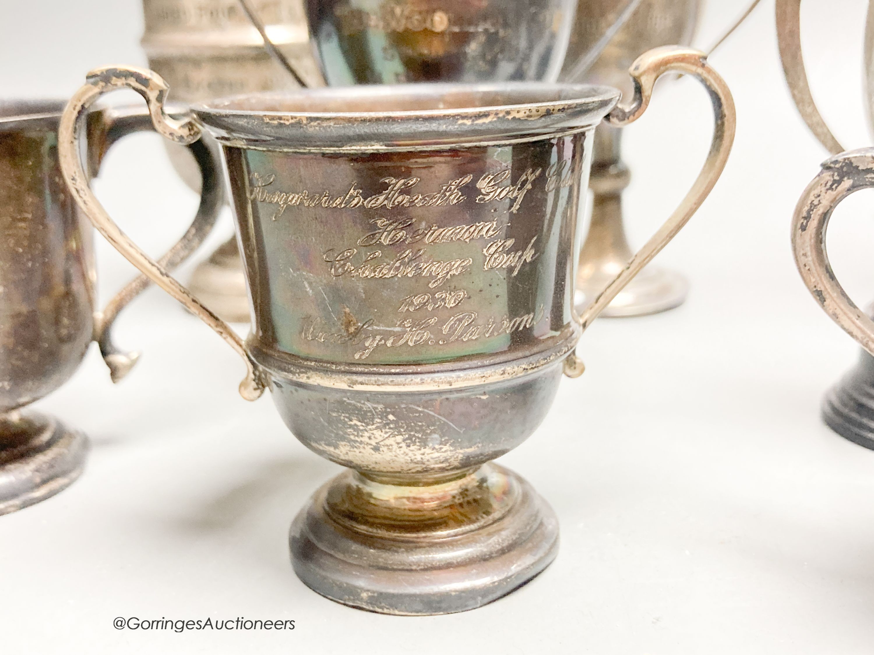 Eight assorted small silver trophy cups and one plated cup, tallest 11.3cm, 11.5oz.